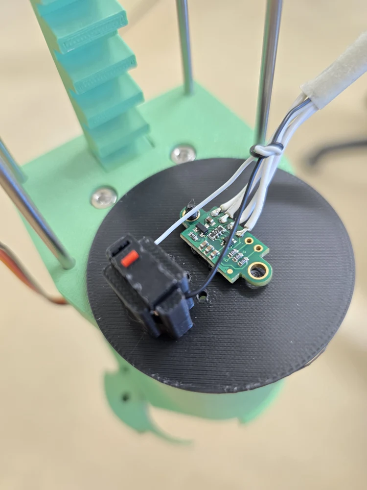 Existing build photo: the downward-facing distance sensor inside the gripper assembly.
